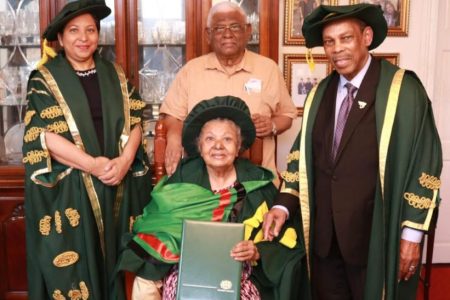 Ameena Gafoor (seated) after being conferred with an Honorary Degree of Doctor of Letters by the University of Guyana in 2022. Also in photo are; Chancellor Professor Edward Greene (right), Vice-Chancellor Professor Paloma Mohamed Martin (left) and husband, Dr Sattaur Gafoor.
