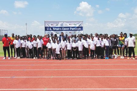 Several of the participants pose for a photo opportunity with the US Olympians and local officials following the commencement of the US Sports Envoy programme at the National Track and Field Centre (NTFC), Edinburgh, West Coast Demerara