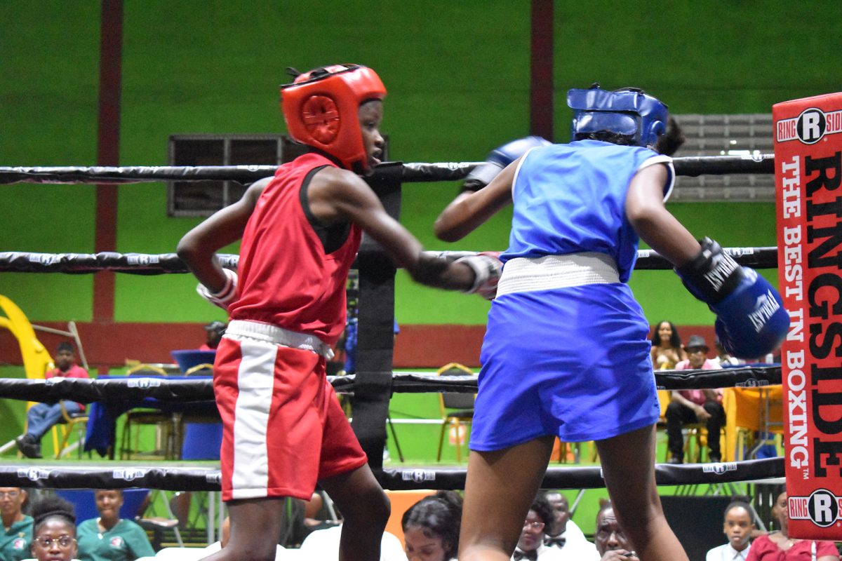 Kenisha Klass (red) of Guyana is in control against Grace Harry of T&T in the Schoolgirls 13-14 (44Kg final). (Zaheer Mohamed photo)
