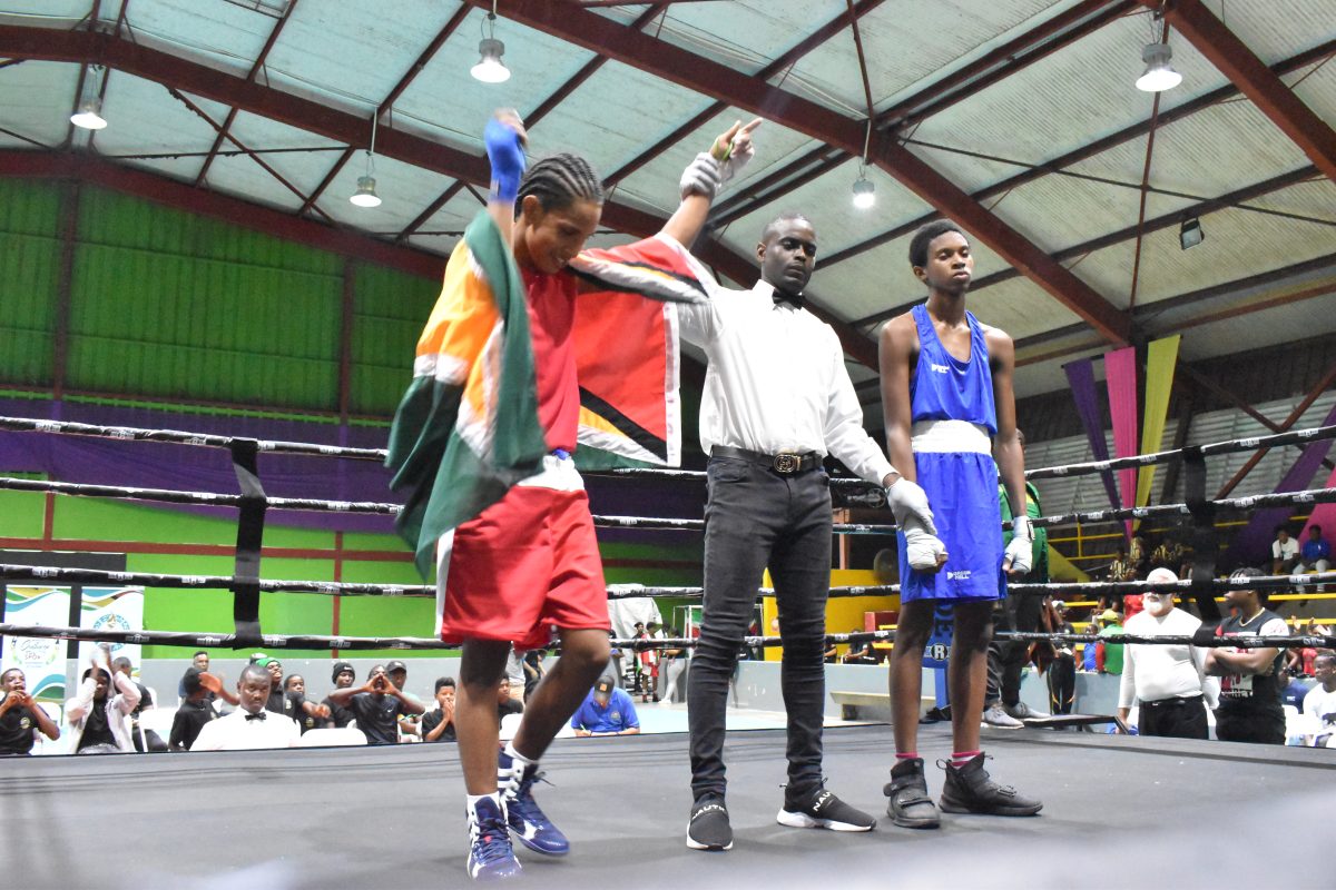 Guyanese Ryan Rogers (red) proved too much for Joshua Brathwaite of Grenada in their matchup (Zaheer Mohamed photos).