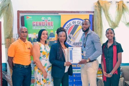 CEO of Genuine Products, Malba LaGoudoue receives the Made in Guyana Certificate