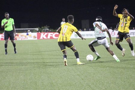 Kelsey Benjamin (centre) is trying to maintain possession while being challenged by Rondell Peters (left) and Randolph Wagner of the Western Tigers