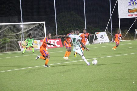 Abumchi Benjamin (no.10) of GDF is in the process of attempting a strike on goal against Fruta Conquerors