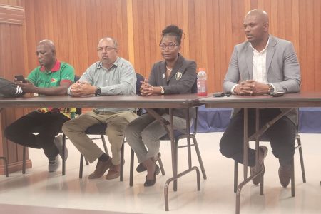 GOA President Godfrey Munroe (right) addresses the media at the Olympic House in Liliendaal.