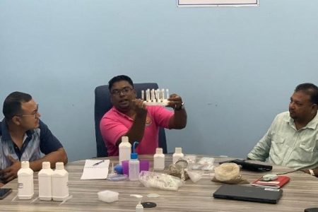 Guyana Rice Development Board  Research Assistant Munindra Seeraj doing a demonstration of the soil testing kit for farmers
