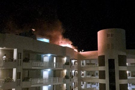 A fire burns at the Double Tree Hotel after a helicopter crashed into the roof in Cairns (Reuters)