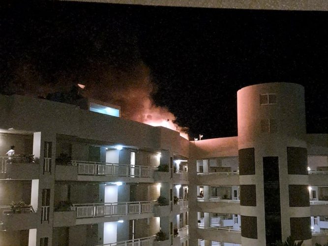 A fire burns at the Double Tree Hotel after a helicopter crashed into the roof in Cairns (Reuters)