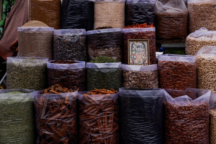 FILE PHOTO: A photo of the Hindu God Lord Ram is placed next to bags filled with Indian spices and dry fruits at a roadside make-shift shop in the old quarters of Delhi, India, May 3, 2024. REUTERS/Anushree Fadnavis/File Photo