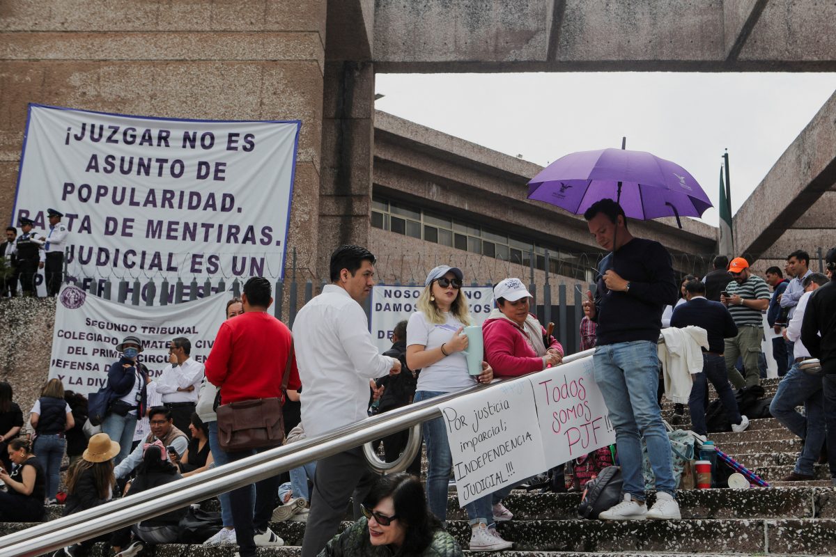 FILE PHOTO: People stand outside the building of the Federal Judiciary Council as Mexico’s judicial workers launched an indefinite nationwide strike ahead of votes by lawmakers on overhauling the country’s judiciary, including moving to the popular election of judges, in Mexico City, Mexico August 19, 2024. REUTERS/Paola Garcia/File Photo