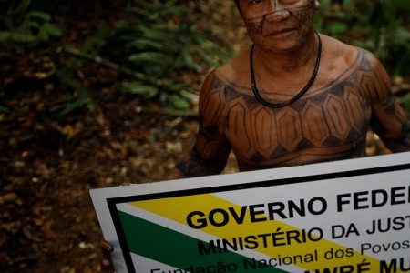 Juarez Saw poses for a picture holding a demarcation sign during the expedition of Munduruku people to mark the frontier of the Sawre Muybu Indigenous Territory, Brazil, July 19, 2024. REUTERS/Adriano Machado