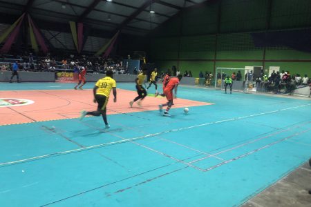 Part of the action in the ‘Keep Ya Five Alive’ Futsal Championship between North Ruimveldt (orange)  and Bent Street (yellow)