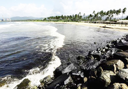 Oil slick is seen in the ocean and covering the rocks on a beach near the Venezuelan state oil company PDVSA's El Palito refinery, in Boca de Aroa, Venezuela August 16, 2024
