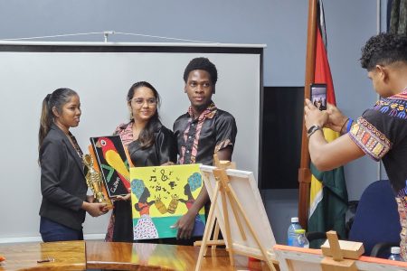 Staff of the Ministry of Tourism, Industry and Commerce and its subvention agencies participated in a painting competition on Wednesday to celebrate Emancipation Day. Teams of two used acrylic and watercolours to create paintings on canvas.
The paintings captured the essence of Emancipation celebrations in Guyana, showcasing local scenes and cultural representations.
After more than two and a half hours of creative expression, Bibi Khatoon and Mark Percival of GNBS emerged as the winners. Ronaldo Persaud and Manog Primo, also from GNBS, secured second place, while Jewel Fredericks and Odessa Burrowes from the Department of Tourism claimed third place.  In this Ministry of Tourism photo the winners pose with their creations.