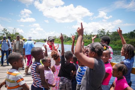  Baracara, Berbice River children interacting on Wednesday with Minister of Education Priya Manickchand during her visit to the area. (Ministry of Education photo)
