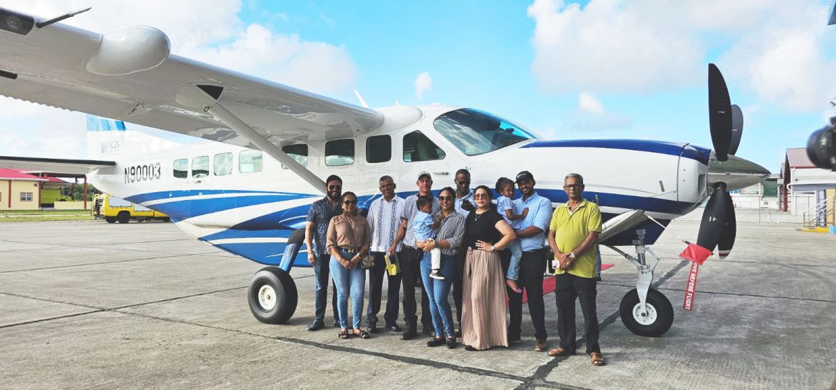 Brian Tiwarie Snr (third from left) poses with others in front of the plane