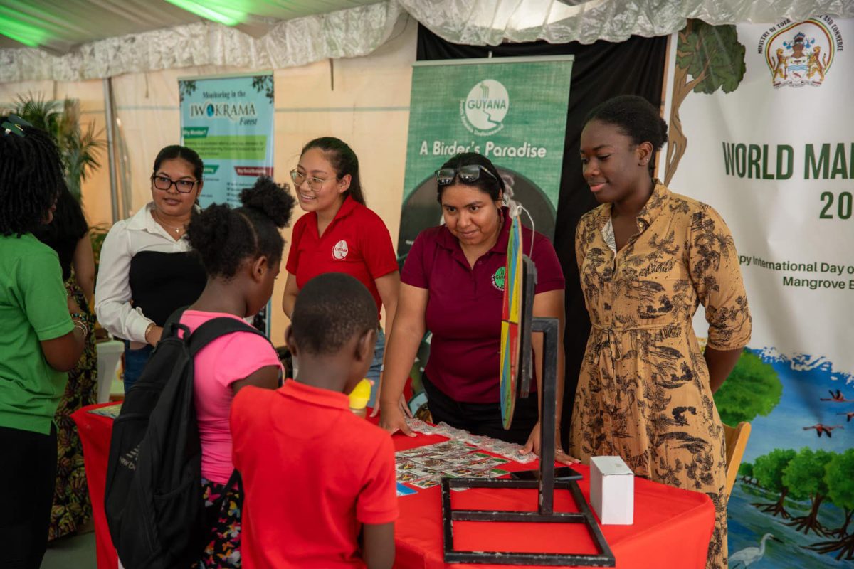 The Environmental Management Consultants Guyana recently teamed up with the Guyana Tourism Authority, responsible for developing and promoting sustainable tourism in Guyana, at the International Day for Conservation of Mangrove Ecosystem exhibition. In this photograph children are being informed about the ecosystem at the recent exhibition.