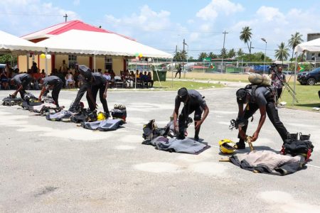 Displaying skills: Firemen yesterday during a simulation exercise during the graduation of 97 new fire fighters. (Guyana Fire Service photo)
