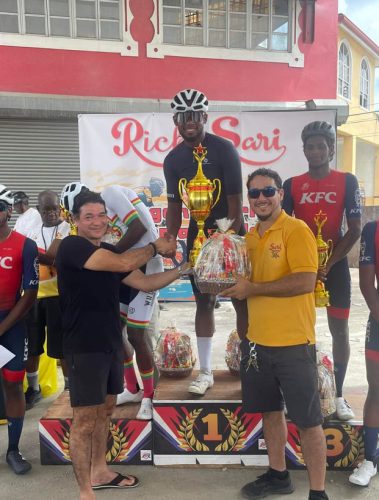 Jamual John receives his prizes from Carlos Rodrigues (right), son of the late Regan Rodrigues, in the presence of another relative