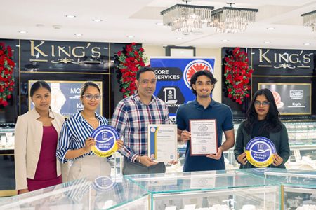 Management and Staff of King’s Jewellery World pose with the GNBS Certificate, Plaque and Stickers.