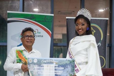 Newly crowned Miss Caribbean Culture Queen 2024 Shequana Holder is presented with a trip for two to the Kaieteur Falls compliments of the Ministry of Tourism, Industry and Commerce (Michael Bonds photo)