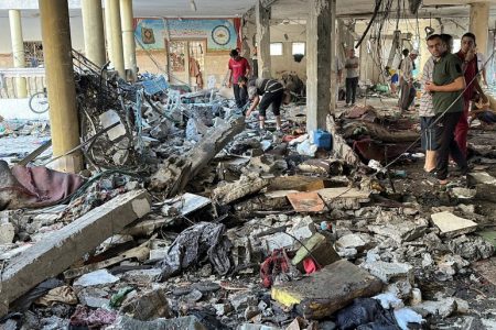 Palestinians inspect the site of an Israeli strike on a school sheltering displaced people, amid the Israel-Hamas conflict, in Gaza City, August 10, 2024. REUTERS/Abed Sabah