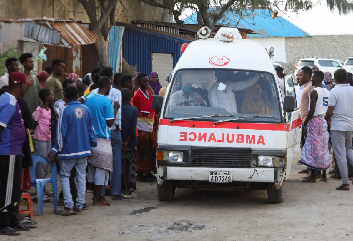 People gather as an ambulance carries the body of an unidentified woman killed in an explosion that occurred while revellers were swimming at the Lido beach in Mogadishu, Somalia August 3, 2024. REUTERS/Feisal Omar