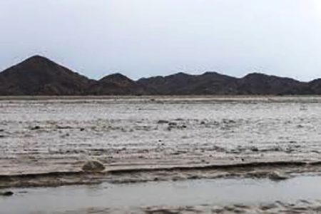 Flood water creates a channel, with the Red Sea mountains visible in the background, in Port Sudan, Sudan, August 26, 2024. REUTERS/El Tayeb Siddig