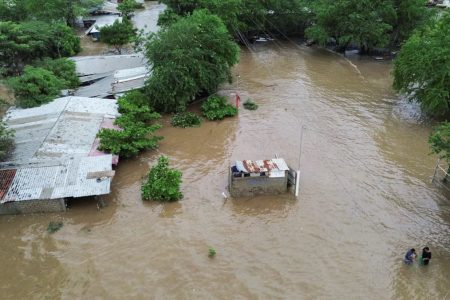 A drone view shows flooded houses and areas damaged by a river overflow, after the passing of Tropical Storm John, in Lazaro Cardenas, Michoacan state, Mexico September 28, 2024.