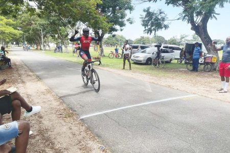 Segun Hubbard reacts as he crosses the finish line unchallenged to win the feature event of the P&P Insurance Cycling Meet
