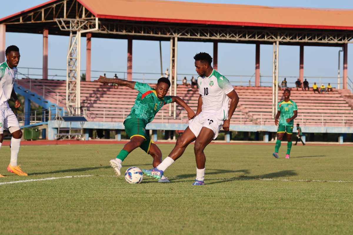 Nathan Moriah-Welsh (no.6) tries to win possession from Suriname’s Virgil Misidjan