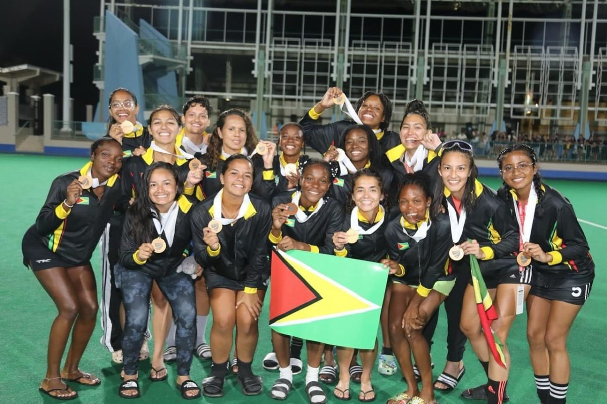 Team Guyana posing with their bronze medal after defeating Bermuda 2-1