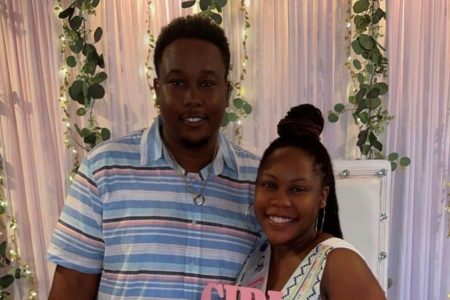 Regina Rawlins and her husband at their baby’s shower 