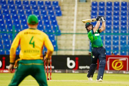 Ross Adair smashes a delivery to the boundary during his match-winning century against South Africa.