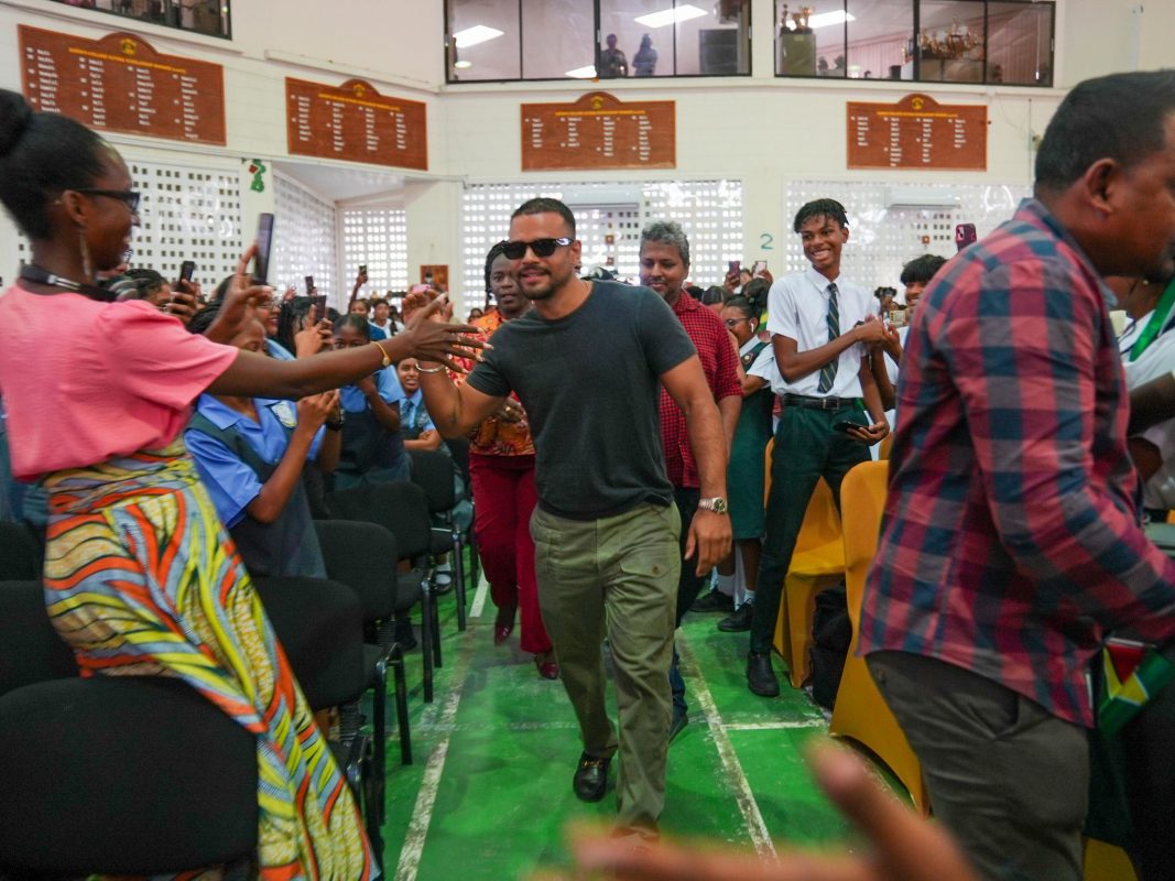  Actor Jacob Scipio (centre), known for his role in the film ‘Bad Boys,’ and his brother Zach, sons of a Guyanese father from Leguan, visited Queen’s College yesterday for a programme of activities, a release from the Ministry of Education said.
During the visit, Jacob took part in a lively Q&A session with students, sharing insights about his journey in the entertainment industry. He spoke candidly about the challenges he faced and the valuable lessons he learned. (Ministry of Education photo)