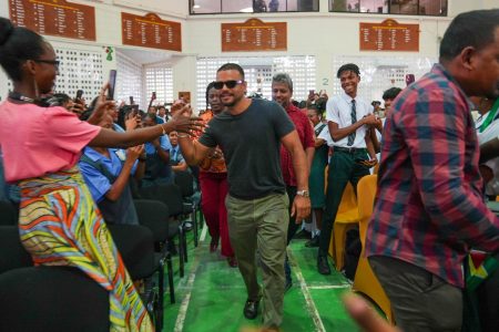  Actor Jacob Scipio (centre), known for his role in the film ‘Bad Boys,’ and his brother Zach, sons of a Guyanese father from Leguan, visited Queen’s College yesterday for a programme of activities, a release from the Ministry of Education said.
During the visit, Jacob took part in a lively Q&A session with students, sharing insights about his journey in the entertainment industry. He spoke candidly about the challenges he faced and the valuable lessons he learned. (Ministry of Education photo)