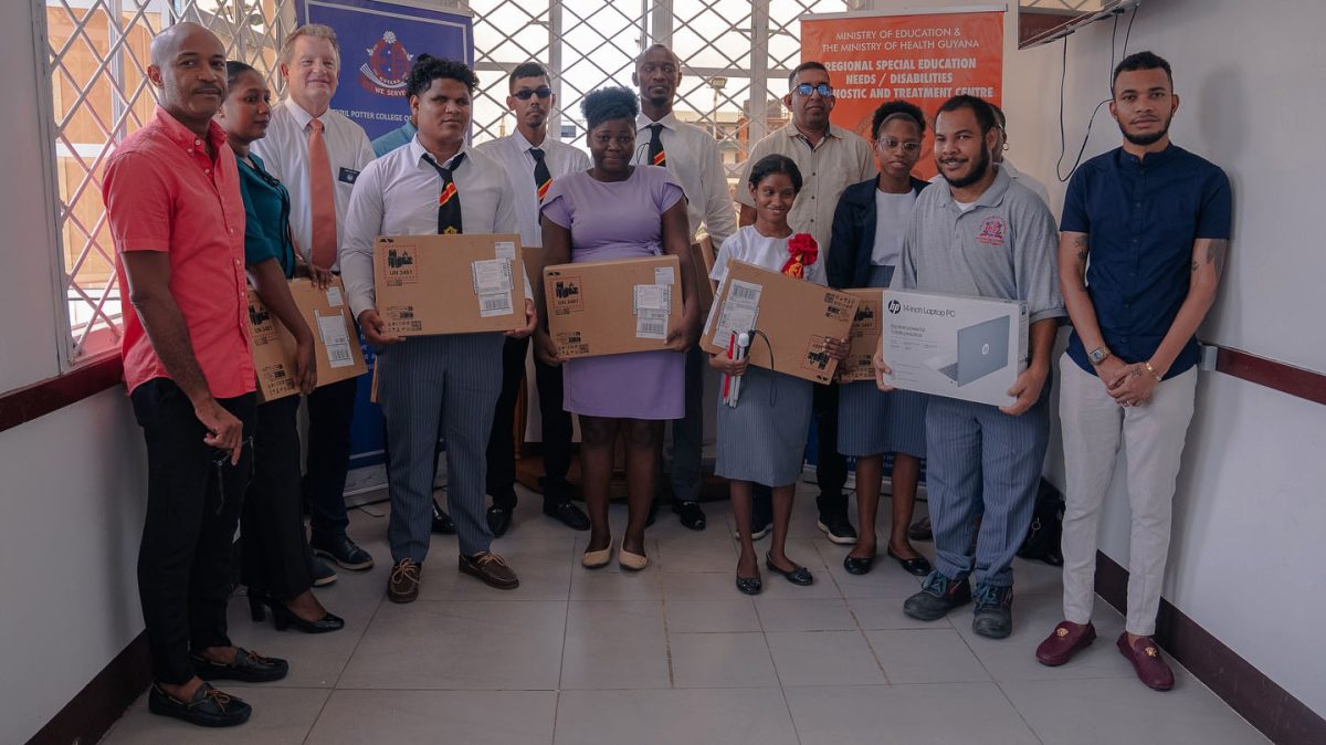 The trainee teachers posing with their laptops (Ministry of Education photo)
