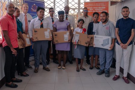 The trainee teachers posing with their laptops (Ministry of Education photo)
