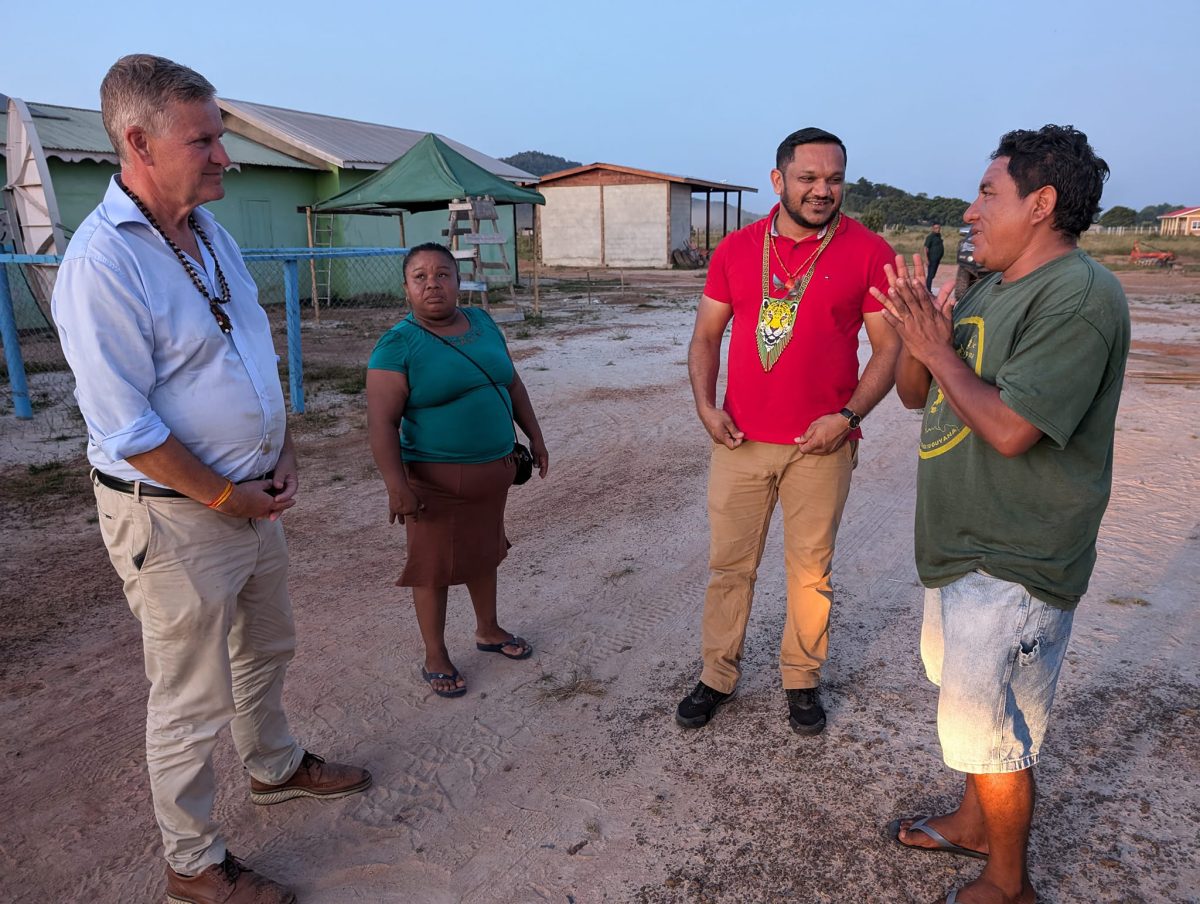 Eric Solheim (left) during his visit to the hinterland. Minister of Natural Resources Vickram Bharrat is second from right. (Ministry of Natural Resources photo)