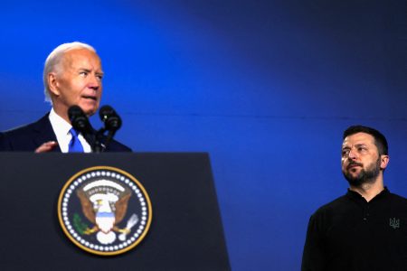 FILE PHOTO: Ukraine's President Volodymyr Zelenskiy listens to U.S. President Joe Biden speak during a Ukraine Compact meeting, on the sidelines of the NATO's 75th anniversary summit in Washington, U.S., July 11, 2024. REUTERS/Leah Millis/File Photo