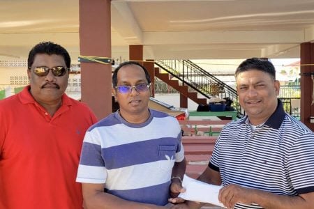 (L-R) Anil Beharry, BCB’s Dr. Cecil Beharry, and
Romash Munna at the simple handing over ceremony.