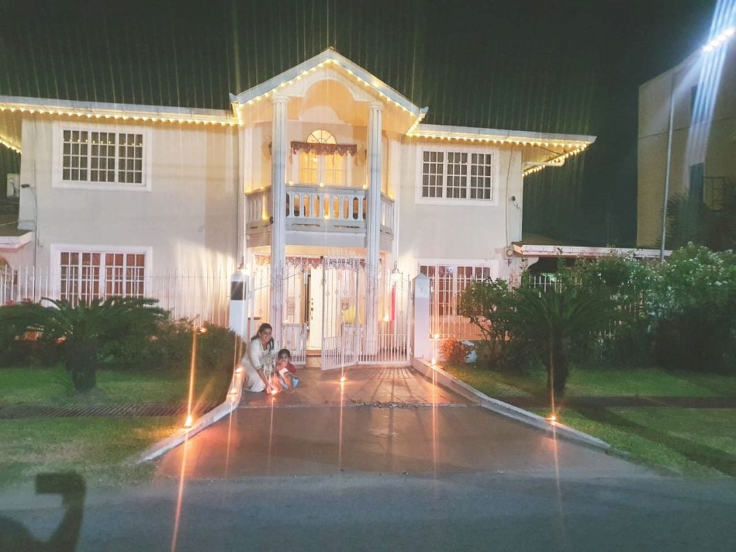 A little girl assist in the lighting of diyas at her Bel Air home
