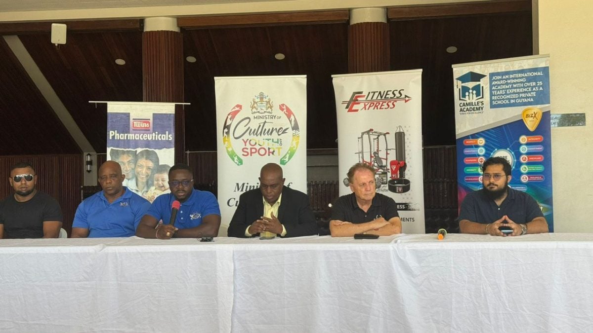 GBBFF President Keavon Bess (3rd from left) addresses the gathering at the launch of the CAC Bodybuilding & Fitness Championships. Also in the photo are Director of Sport Steve Ninvalle (4th from left), CACFBC Treasurer Edward Malone (5th from left), CACFBC Vice-President Roger Boyce (2nd from left), GBBFF Organising Secretary Videsh Sookram (1st from left), and Twins Manufacturing Representative Noah Ferouz.