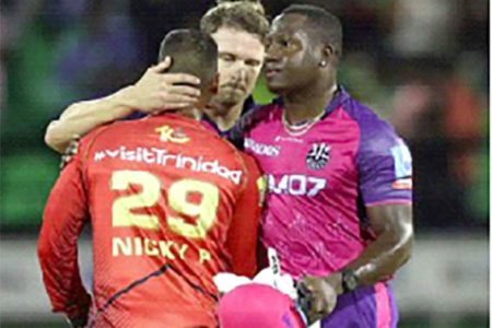 COMMISERATIONS: Barbados Royals skipper Rovman Powell and David Miller console Trinbago Knight Riders’ Nicholas Pooran at the conclusion of their Caribbean Premier League eliminator match at Providence Stadium, in Georgetown, Guyana, last Tuesday. —Photo: Ashley Allen-CPL T20