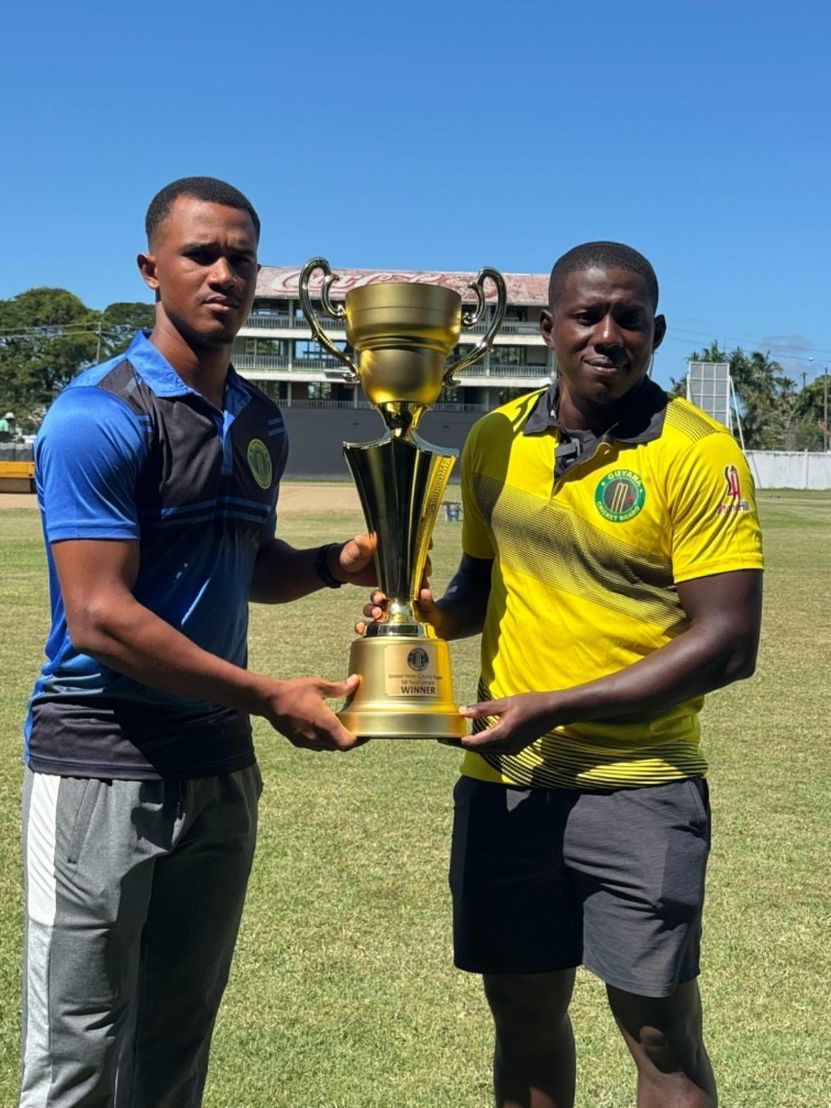 Demerara captain Tevin Imlach (left) and his Essequibo counterpart Antony Adams posed for a photo at the GCC ground in Bourda with the GCB Inter-County Super50 that will be at stake today at the same venue.