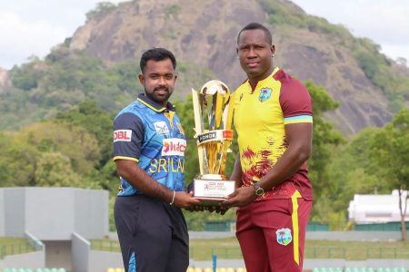 West Indies captain Rovman Powell (right) poses with the T20I series trophy alongside his Sri Lankan counterpart Charith Asalanka