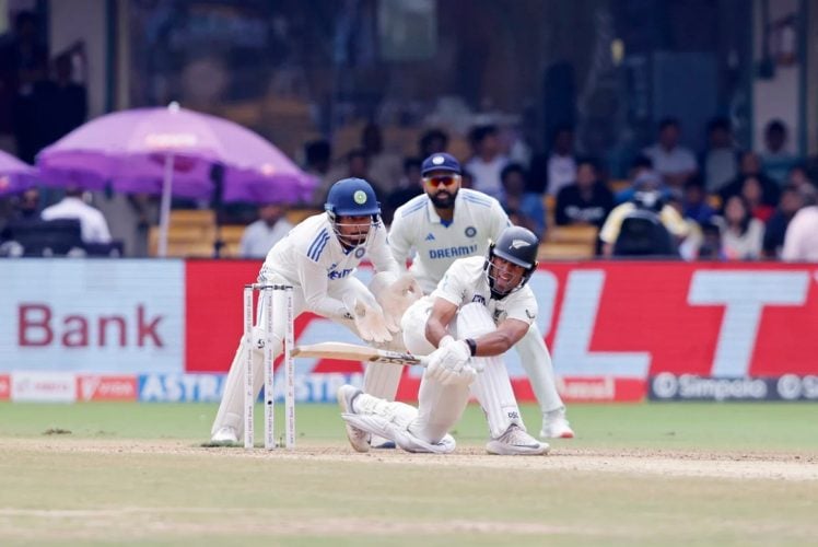 Rachin Ravindra sweeps to the leg-side during his unbeaten 39 (ESPN Cricinfo Photo).