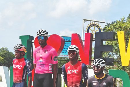 Jamual John (centre) stands atop the podium after capturing the first stage of the inaugural One Guyana 3-Stage Cycling in Berbice. Standing on the left is Aaron Newton, who was second, while Cortis Dey (2nd from right) rounded out the top three. Finishing in fourth was Briton John