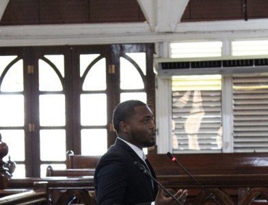 The winning team: Fabian Green - Senior Counsel (standing), Raheem Blair - Researcher (centre), and Juneeda Jeffers - Junior Counsel
