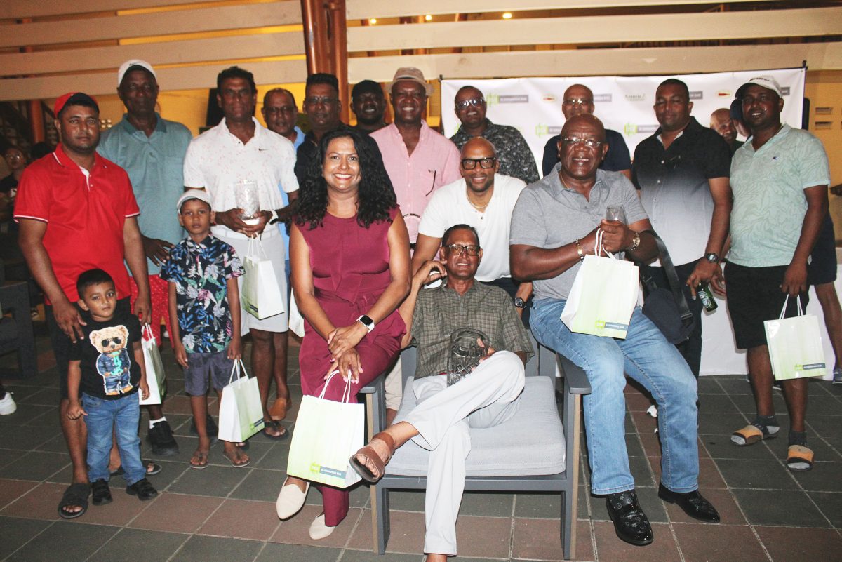 Patrick Prashad (sitting) poses with other members of team Guyana after winning the A-Class category
