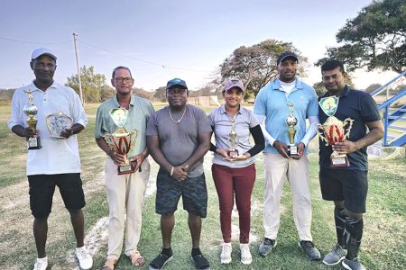 The respective winners in the Atlas Security Service Golf
Tournament pose with their spoils following the conclusion of the event.